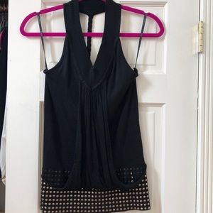 Black Bebe top with soft gold studs at waist.
